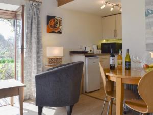 a kitchen and dining room with a table and chairs at Tamar Orchard Barn in Gunnislake