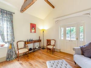 a living room with a couch and a table at Apartment At Llanerchydol Hall in Welshpool