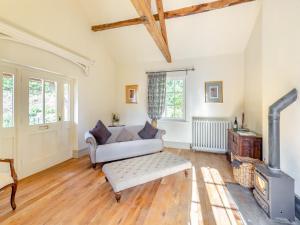 a living room with a couch and a fireplace at Apartment At Llanerchydol Hall in Welshpool