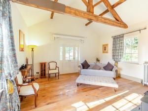 a living room with a couch and a table at Apartment At Llanerchydol Hall in Welshpool