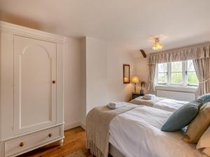a bedroom with a large bed and a window at Swallow Cottages, No 1 - Uk46811 in Thurgarton