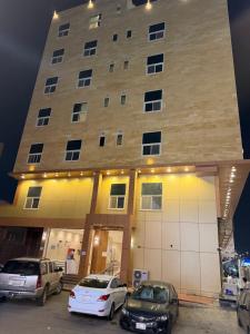two cars parked in front of a building at Marina Jada hotel in Jeddah