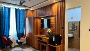 a bathroom with a television on a desk with a sink at Sunny Pines Resort in Lansdowne