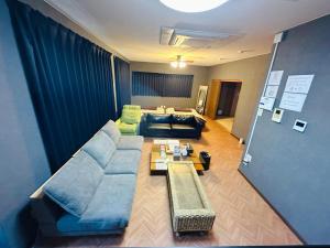 a living room with a couch and a table at Hotel EL Utsunomiya 7 free parking in Utsunomiya