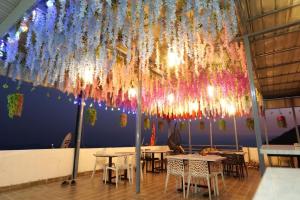 a dining room with tables and a large chandelier at Sunny Pines Resort in Lansdowne