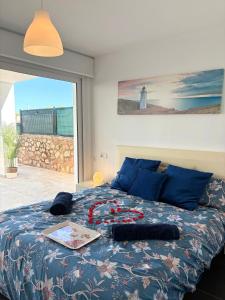 a bedroom with a bed with a table on it at Chalet Barceló Rocher in Cala d´Or