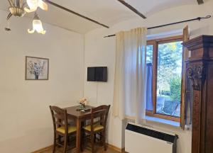 a dining room with a table and a window at Villa Gioia Civita in Fabriano