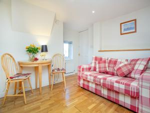 a living room with a couch and a table at Rock House Apartment in Torquay