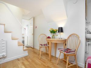 a dining room with a table and two chairs at Rock House Apartment in Torquay