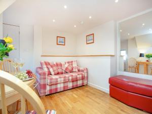a living room with a couch and a table at Rock House Apartment in Torquay