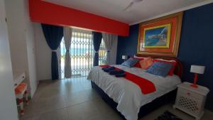 a bedroom with a large bed with blue walls at Nomads Nook 3 in Ramsgate