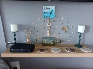 a table with two lamps and a fishtank on a shelf at Nomads Nook 3 in Ramsgate