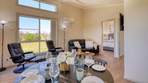 a living room with a table and chairs at Red Hill Cabin#2 - 2-bedroom in Walcha