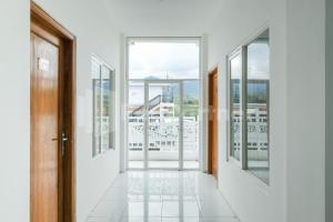 a hallway with doors and windows with a view at Sazara Hotel Batu in Selecta +56 photos