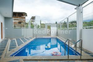 a swimming pool on the roof of a building at Sazara Hotel Batu in Selecta