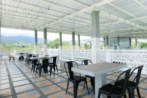 a row of tables and chairs on a patio at Sazara Hotel Batu in Selecta