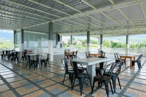 a group of tables and chairs in a room with a view at Sazara Hotel Batu in Selecta