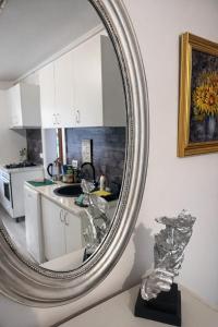 a large silver mirror on a wall in a kitchen at Boheme Studio in Timişoara +31 photos