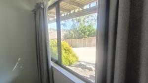 a window with a view of a yard at Suthar's Home in Wellington
