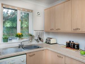 a kitchen with a sink and a window at Gull Cottage in Falmouth +10 photos