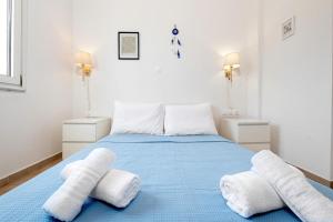 a bedroom with a bed with white towels on it at Gouvia bay Serenity in Gouvia +19 photos
