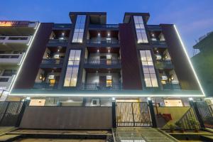 a large building with lights on the side of it at Hotel Elite Clark in Noida