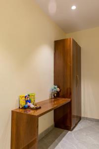 a wooden desk in the corner of a room at Hotel Elite Clark in Noida