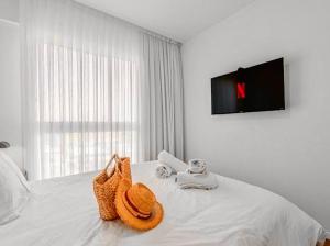 a bedroom with a bed with a tv on the wall at Redsearent suite with pool view in Eilat +10 photos