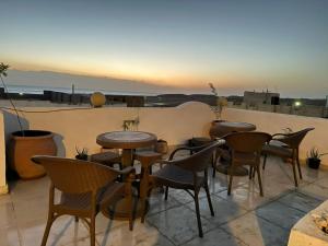 a group of tables and chairs on a patio at Dolphin suites apartment in Marsa Alam City