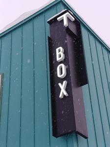 a sign on the top of a building with the word bus at Tbox in Kutchan