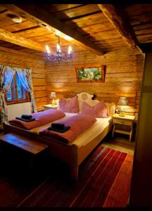 a bedroom with a large bed in a wooden room at FLICHTLHOF Hütte in Abtenau