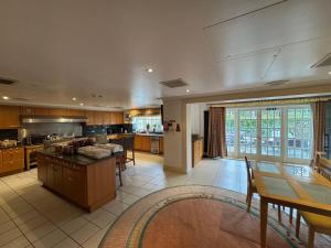 a large kitchen with a table and some chairs at The Bishop in London