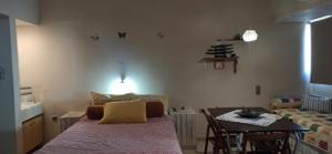 a room with a bed and a table with a dining room at 1st floor studio in Kalathas in Kalathas