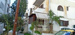 a yellow car parked in front of a building at 1st floor studio in Kalathas in Kalathas