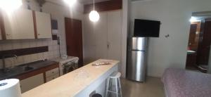 a kitchen with a refrigerator and a counter top at 1st floor studio in Kalathas in Kalathas