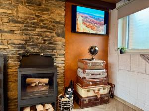 a stack of suitcases next to a fireplace at Travel Wood in Waulsort +48 photos