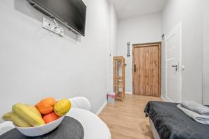 a bowl of fruit sitting on a table in a room at Central Platinum Apartments 1 in Rybnik
