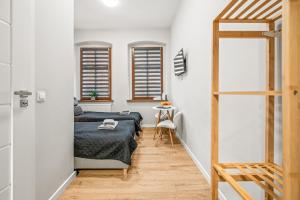 a bedroom with two beds and a table at Central Platinum Apartments 1 in Rybnik