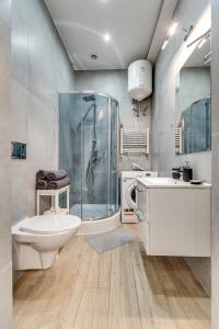 a bathroom with a shower and a toilet and a sink at Central Platinum Apartments 7 in Rybnik