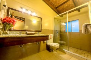 a bathroom with a sink and a toilet and a mirror at Hotel El Maltese - Lakefront in Granada +133 photos