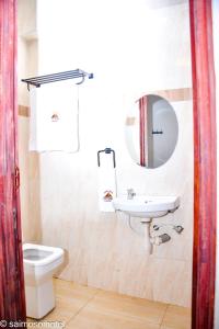 a bathroom with a sink and a toilet and a mirror at Saimo Hotel-Kabarnet in Kabarnet +9 photos