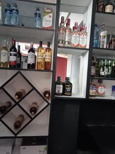 a refrigerator filled with lots of bottles of alcohol at Saimo Hotel-Kabarnet in Kabarnet
