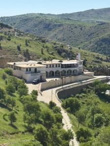 a large white building in the middle of a field at Serge Otel in Arapkir