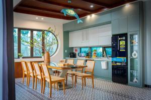 a kitchen with a dining room table and chairs at B'Villa Luxury in Dong Hoi