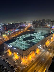 a large building in a city at night at Sahara View Guest House Prime Location on the Dubai Sharjah Border in Sharjah