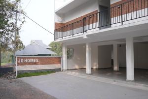 a no homes sign in front of a building at Jo Homes Apartments in Alwaye