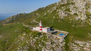 a lighthouse on the side of a mountain at Hotel Boutique Faro Silleiro in Baiona