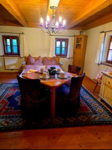 a living room with a table and a couch at Kanzlei in Abtenau