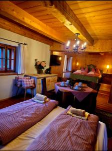 a room with two beds and a living room at Kanzlei in Abtenau