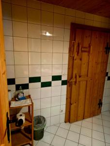 a bathroom with a door and a tiled wall at Kanzlei in Abtenau +31 photos